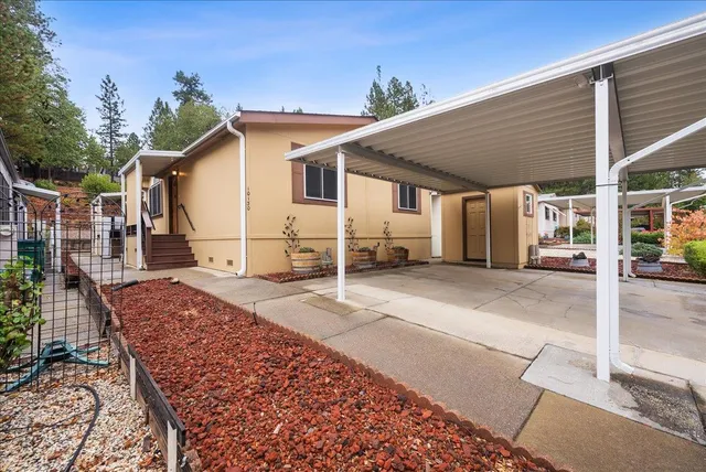 a view of a yard with a house and a tree