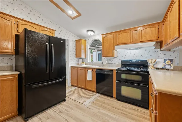 a kitchen with granite countertop stainless steel appliances and wooden cabinets