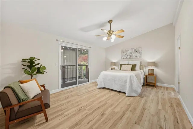 a spacious bedroom with a bed and a chair