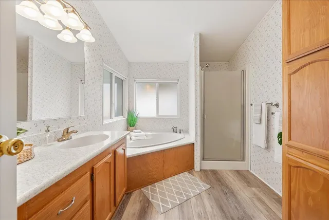 a spacious bathroom with a sink double vanity and a mirror