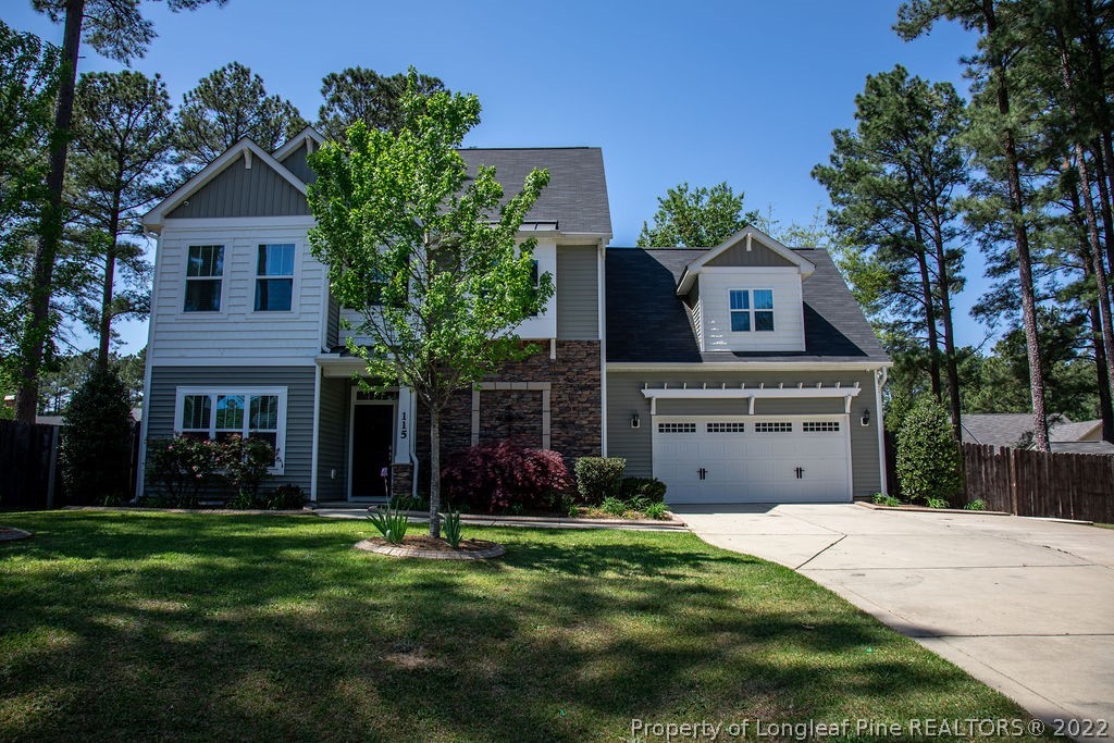 115 Stonehurst Drive Spring Lake, NC 28390 - Photo 1 of 50 a front view of a house with a garden and plants