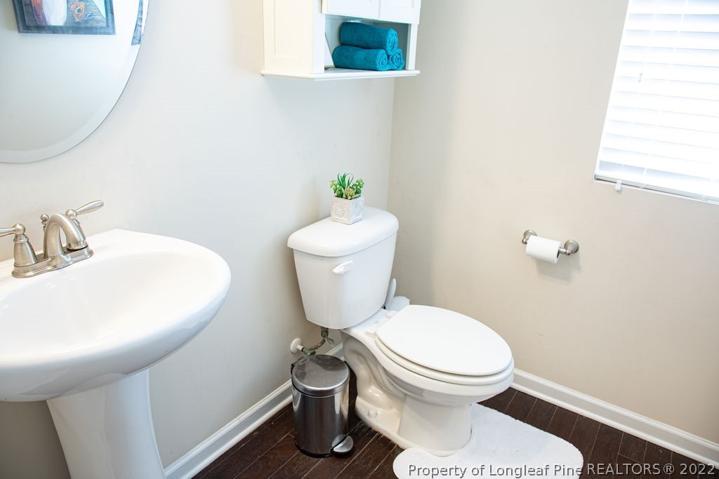 115 Stonehurst Drive Spring Lake, NC 28390 - Photo 11 of 50 a white toilet sitting next to a bathroom sink