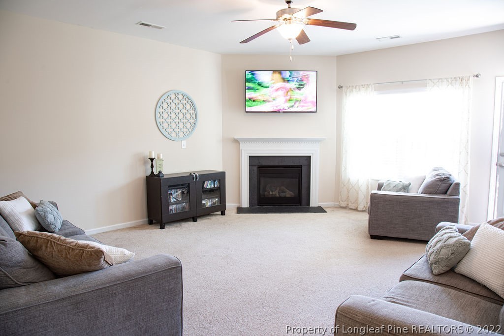115 Stonehurst Drive Spring Lake, NC 28390 - Photo 13 of 50 a living room with furniture and a fireplace