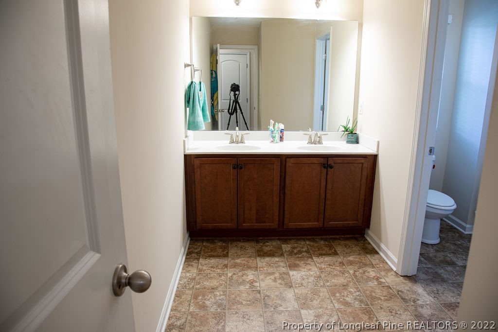 115 Stonehurst Drive Spring Lake, NC 28390 - Photo 24 of 50 a bathroom with a sink and a toilet
