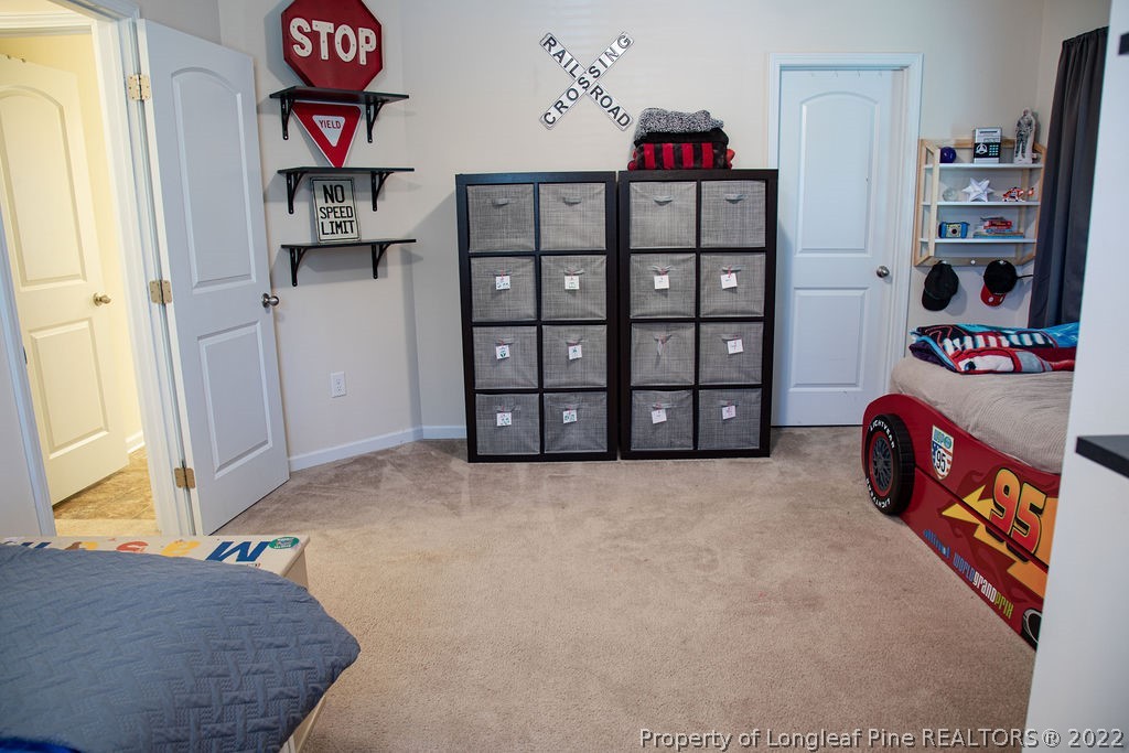115 Stonehurst Drive Spring Lake, NC 28390 - Photo 25 of 50 a view of a bedroom with baby crib and toys