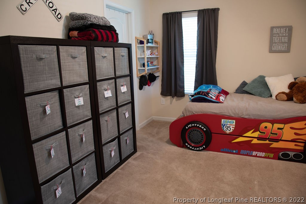 115 Stonehurst Drive Spring Lake, NC 28390 - Photo 26 of 50 a bedroom with a bed and a dresser in it