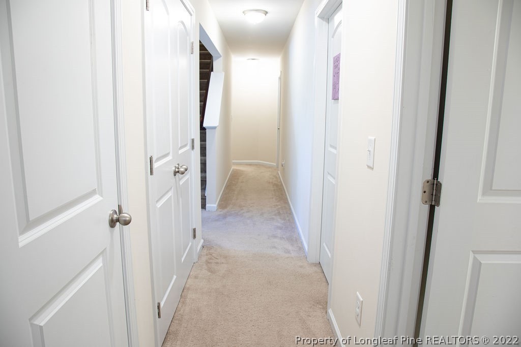 115 Stonehurst Drive Spring Lake, NC 28390 - Photo 28 of 50 a view of a hallway with wooden floor and staircase