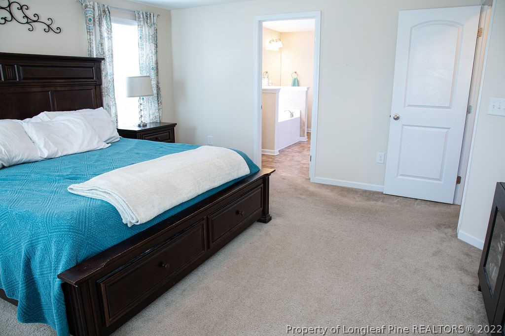 115 Stonehurst Drive Spring Lake, NC 28390 - Photo 30 of 50 a room with a bed and a night stand