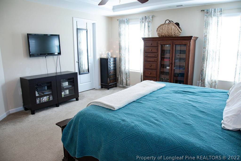 115 Stonehurst Drive Spring Lake, NC 28390 - Photo 35 of 50 a spacious bedroom with a bed and a flat screen tv