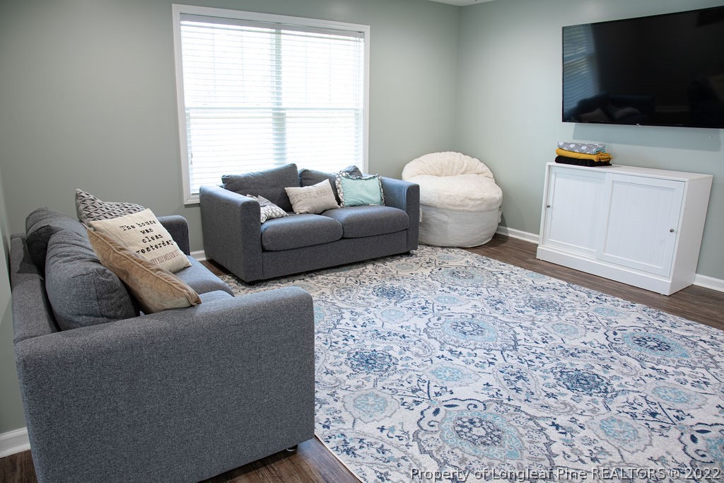 115 Stonehurst Drive Spring Lake, NC 28390 - Photo 42 of 50 a living room with furniture and a flat screen tv