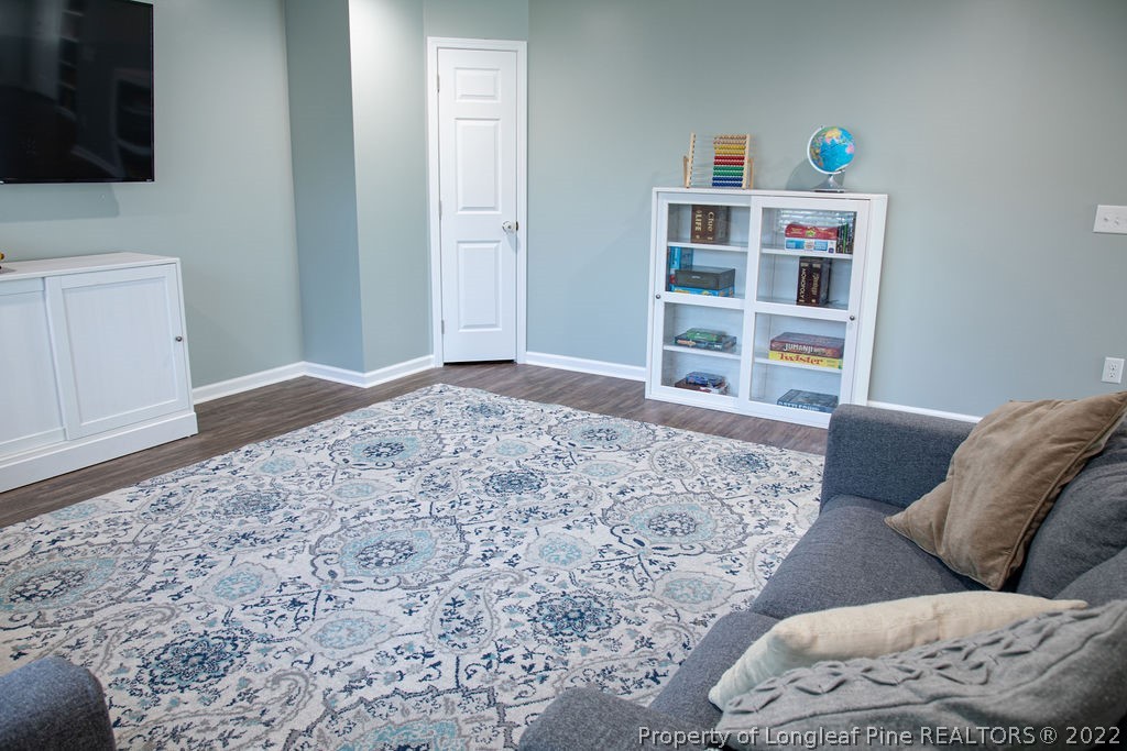 115 Stonehurst Drive Spring Lake, NC 28390 - Photo 45 of 50 a living room with a couch and a flat screen tv
