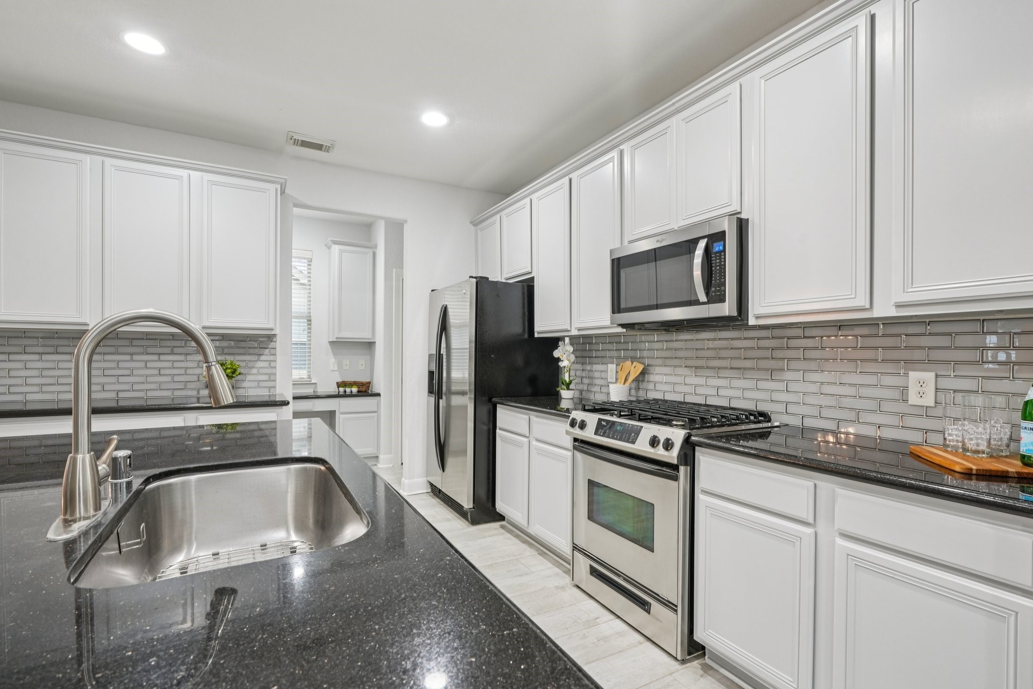 90 Panterra Way Spring, TX 77382 - Photo 12 of 43 a kitchen with a sink appliances and cabinets