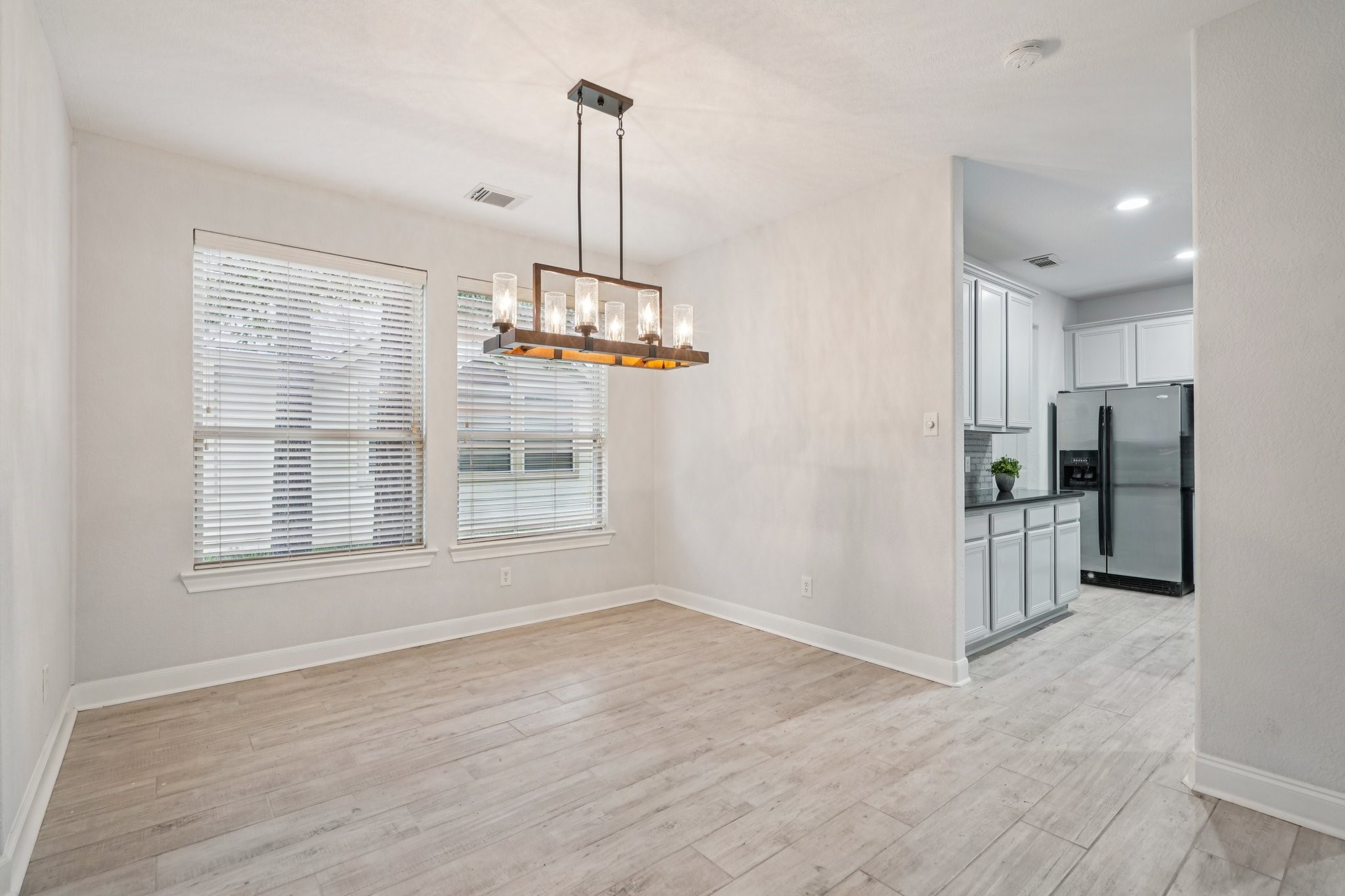 90 Panterra Way Spring, TX 77382 - Photo 16 of 43 a view of an empty room with kitchen and window