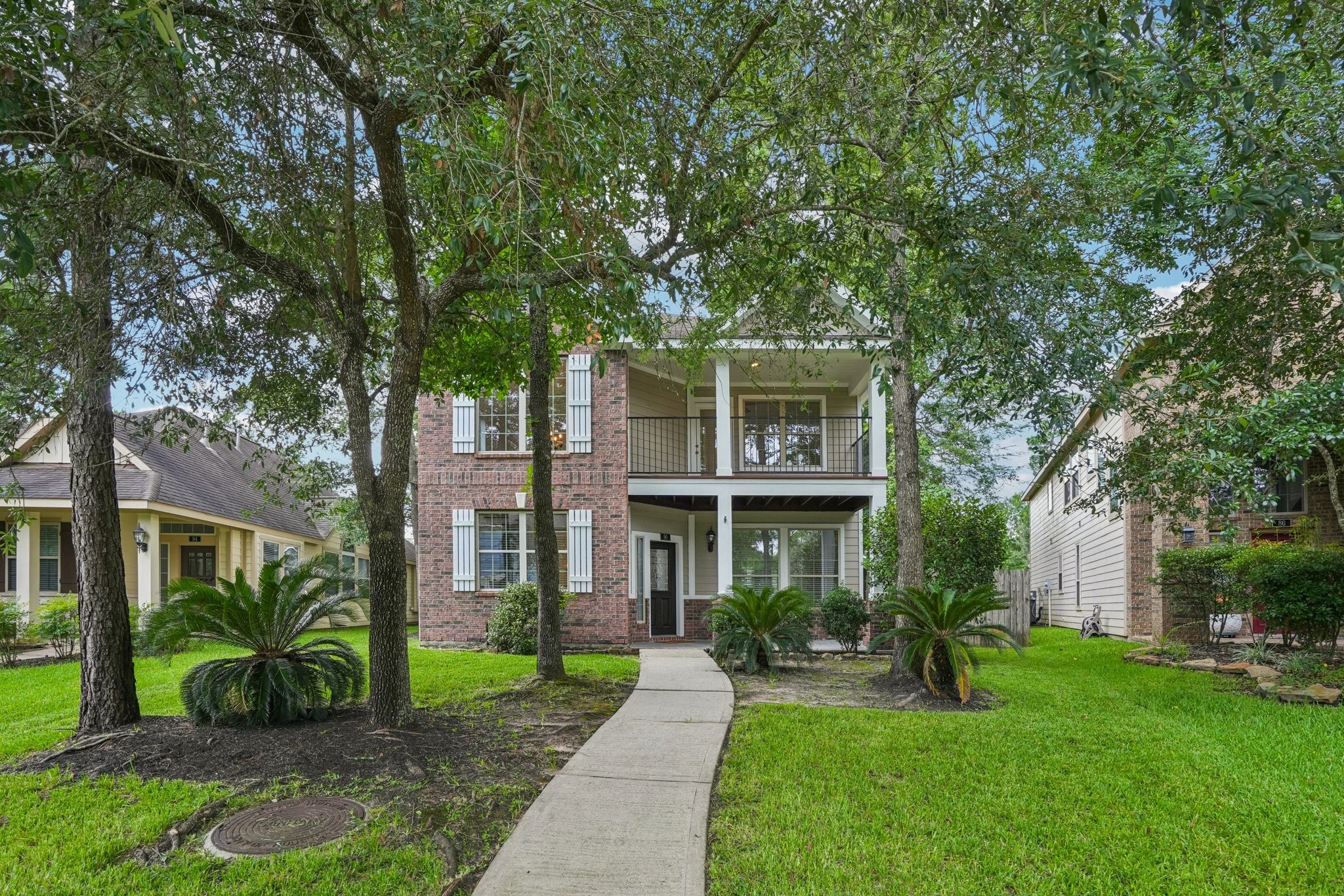 90 Panterra Way Spring, TX 77382 - Photo 2 of 43 a front view of a house with a yard and porch