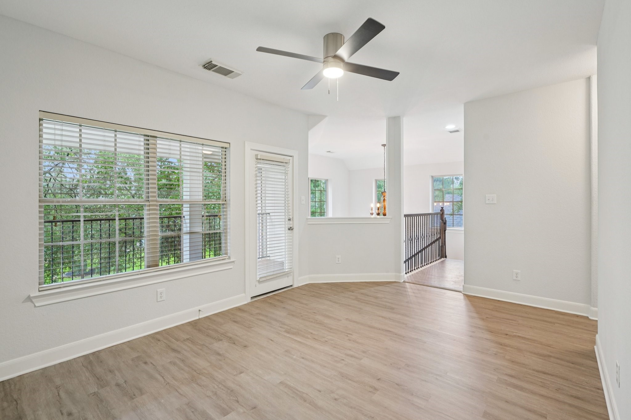 90 Panterra Way Spring, TX 77382 - Photo 22 of 43 a view of an empty room with a window and wooden floor
