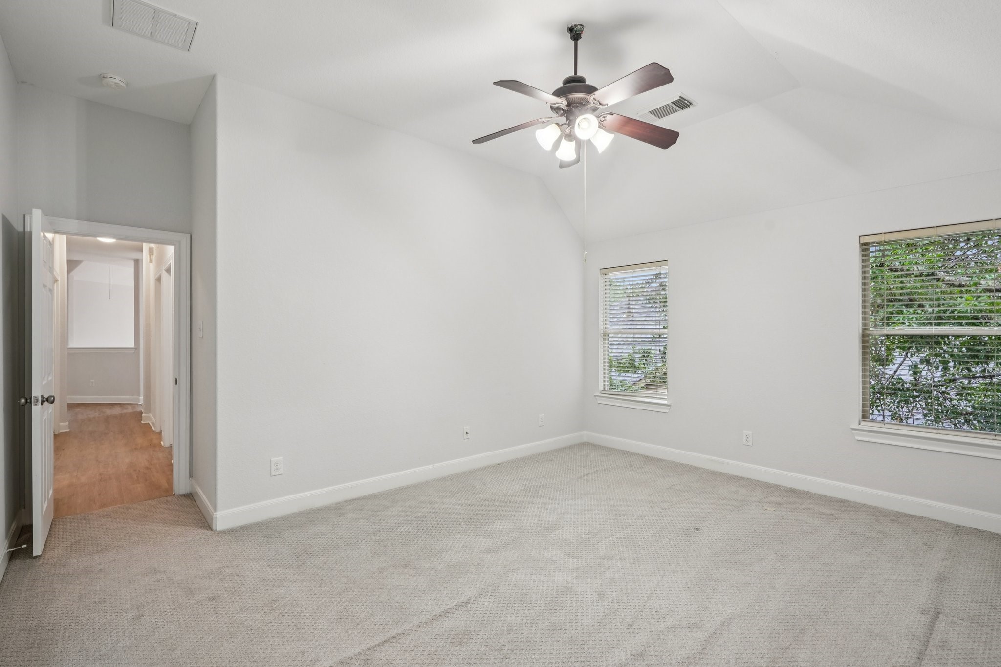 90 Panterra Way Spring, TX 77382 - Photo 25 of 43 an empty room with chandelier fan and windows