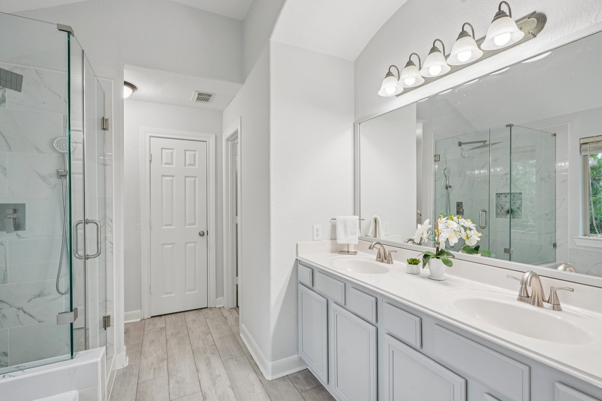 90 Panterra Way Spring, TX 77382 - Photo 26 of 43 a bathroom with double vanity sinks a vanity two mirror and a shower