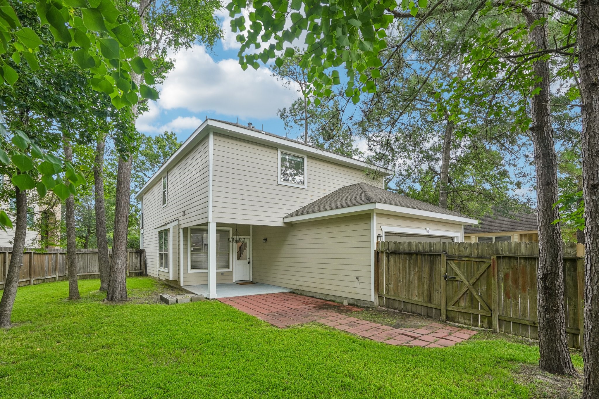 90 Panterra Way Spring, TX 77382 - Photo 40 of 43 a view of backyard with a garden and large trees