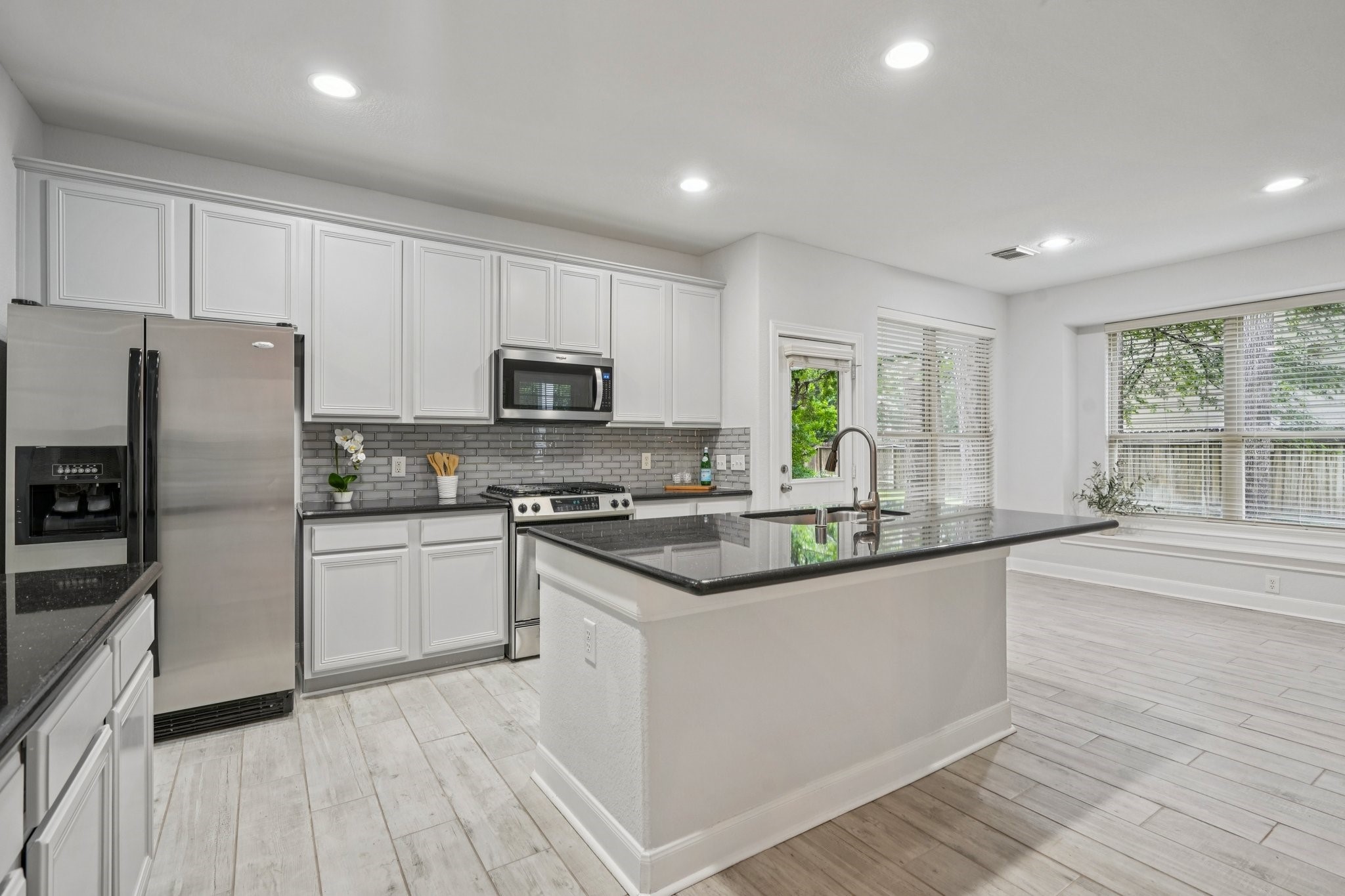 90 Panterra Way Spring, TX 77382 - Photo 9 of 43 a kitchen with stainless steel appliances granite countertop a stove a sink and a refrigerator