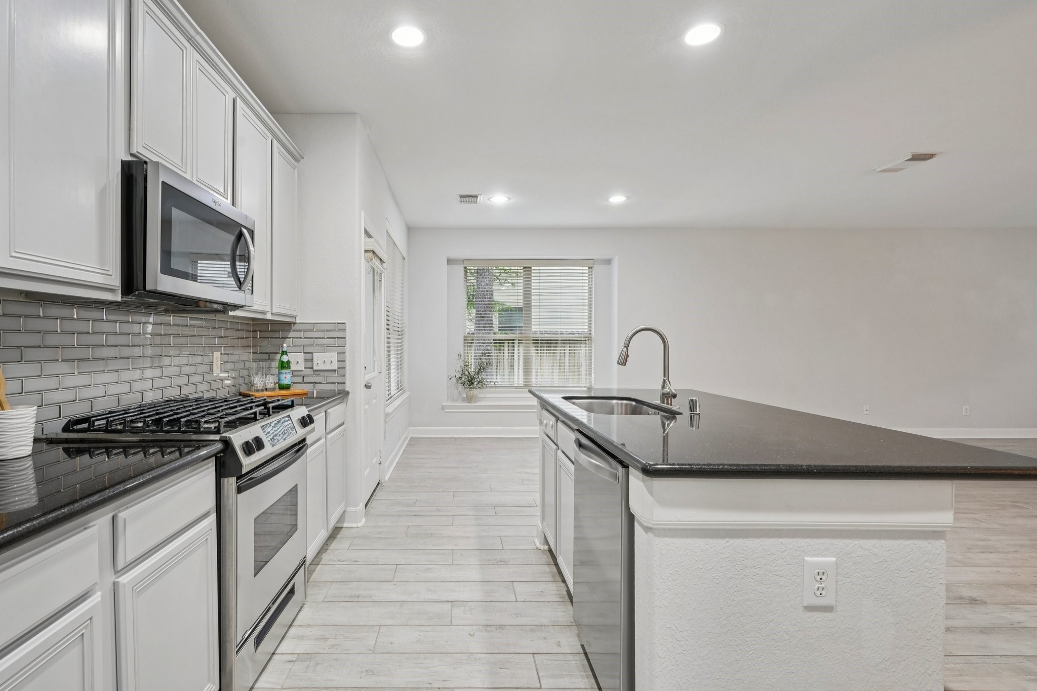 90 Panterra Way Spring, TX 77382 - Photo 10 of 43 a kitchen with kitchen island stainless steel appliances a sink stove and cabinets