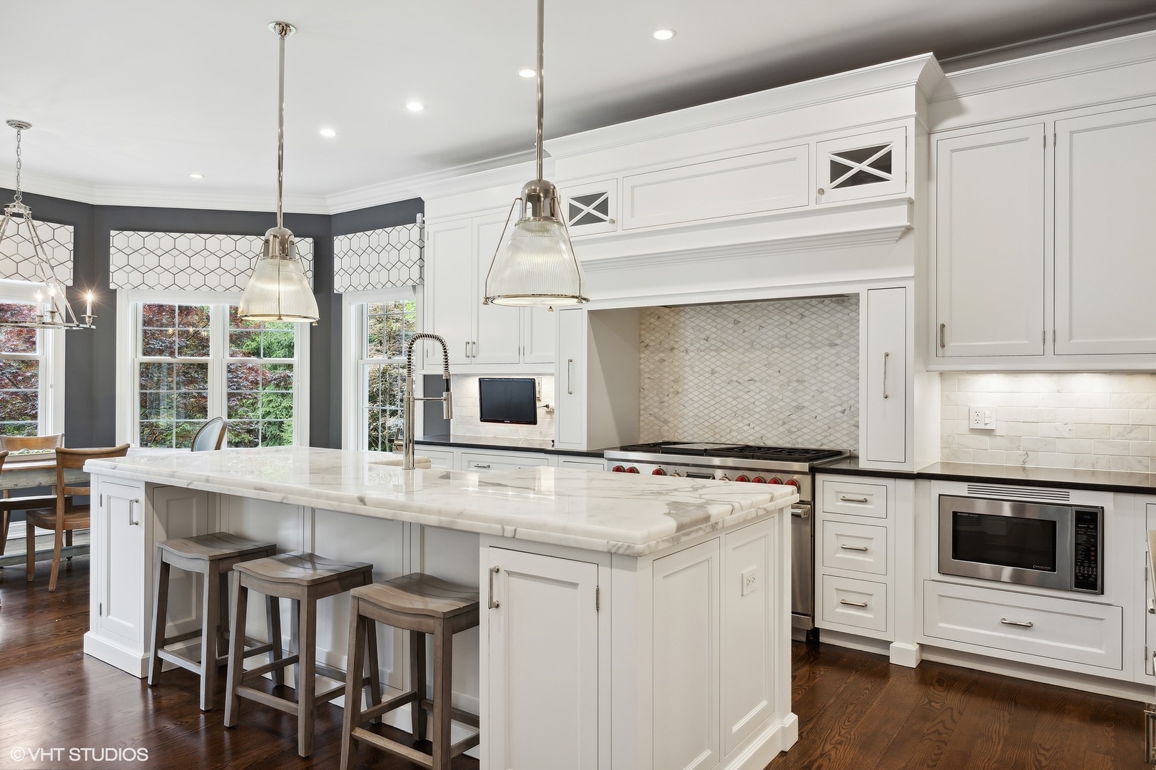 339 Linden Street Winnetka, IL 60093 - Photo 11 of 69 a kitchen with stainless steel appliances granite countertop a stove a sink and white cabinets with wooden floors
