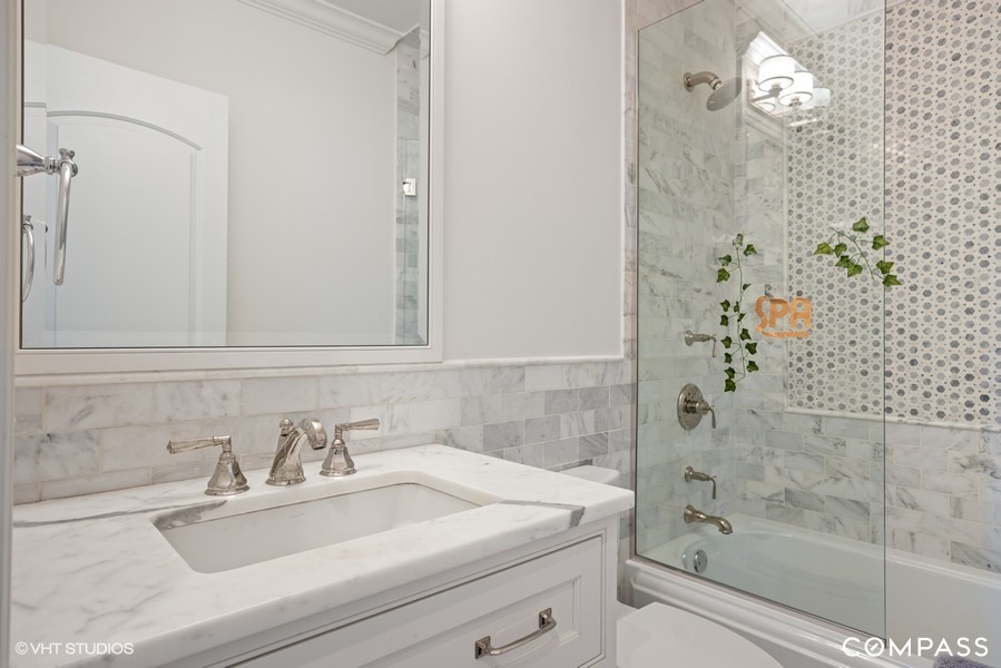 339 Linden Street Winnetka, IL 60093 - Photo 37 of 69 a bathroom with a sink and a mirror
