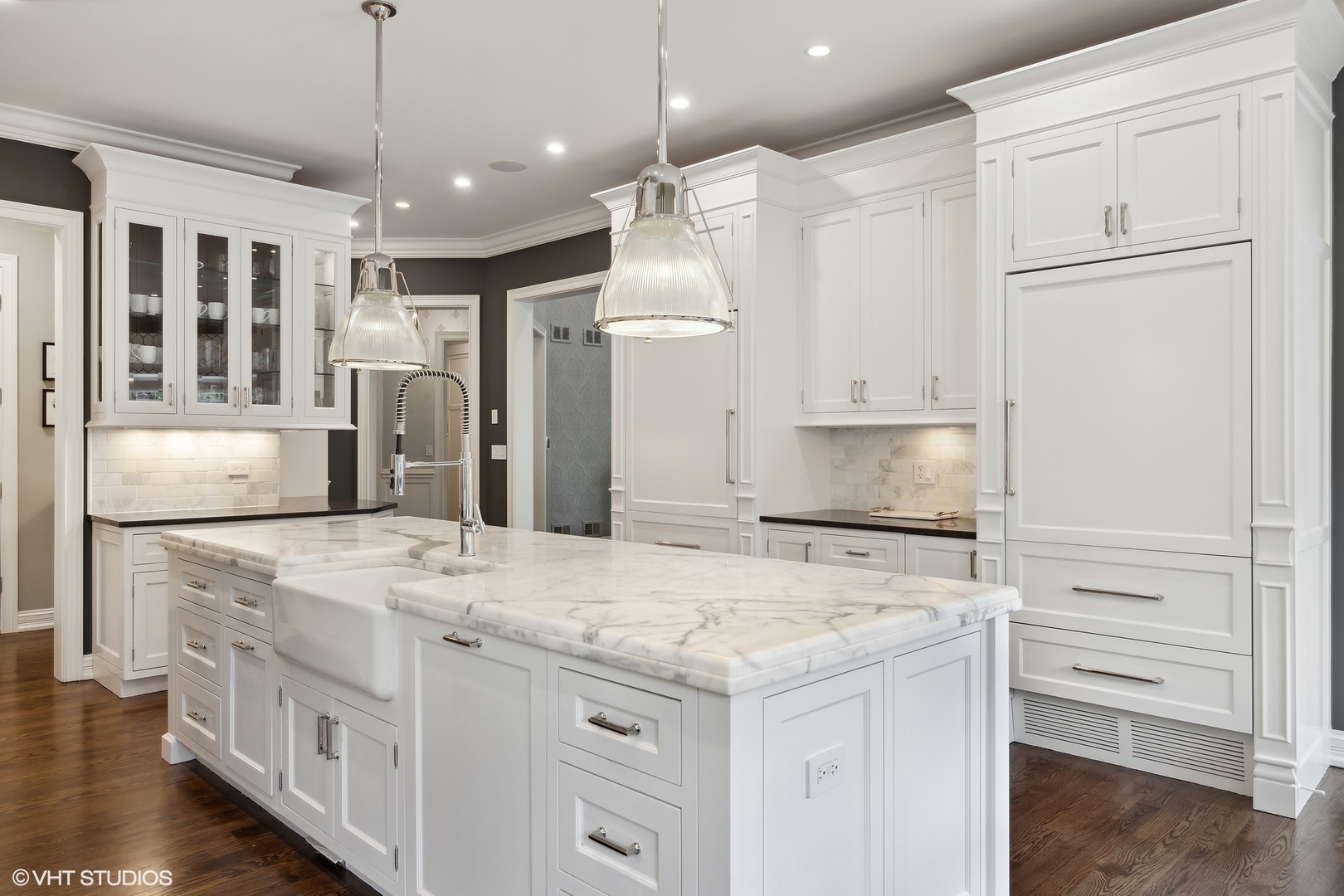 339 Linden Street Winnetka, IL 60093 - Photo 10 of 69 a kitchen with stainless steel appliances granite countertop a refrigerator a oven and white cabinets with wooden floors