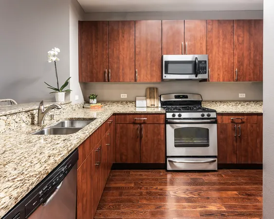 a kitchen with granite countertop a sink and a stove top oven