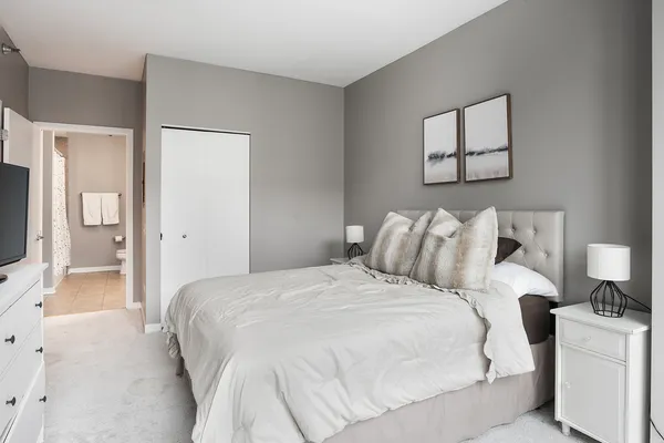 a bedroom with a bed and a flat screen tv