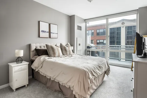a bedroom with a large bed and a tv