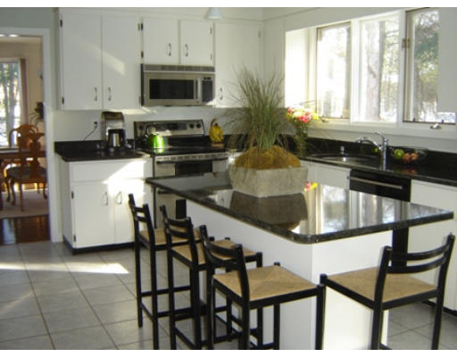 52 Eliot Hill Road Natick, MA 01760 - Photo 13 of 28 a kitchen with stainless steel appliances kitchen island granite countertop a stove a sink and a granite counter tops