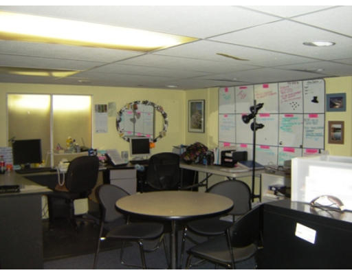 52 Eliot Hill Road Natick, MA 01760 - Photo 25 of 28 a living room with furniture a flat screen tv and a table