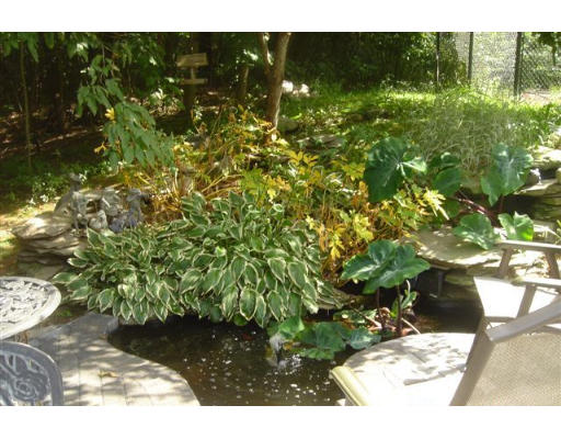 52 Eliot Hill Road Natick, MA 01760 - Photo 28 of 28 a backyard of a house with yard and outdoor seating