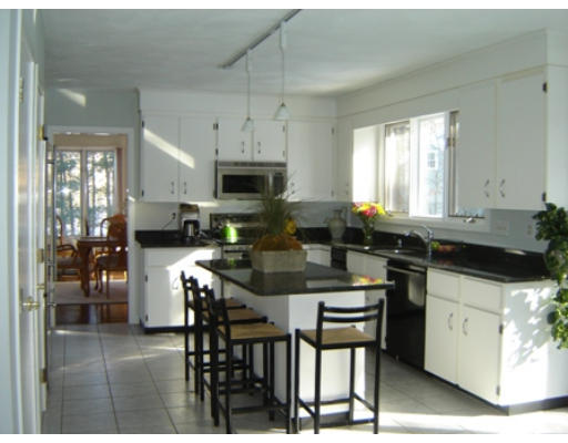 52 Eliot Hill Road Natick, MA 01760 - Photo 3 of 28 a kitchen with stainless steel appliances kitchen island granite countertop a sink a stove a dining table and chairs