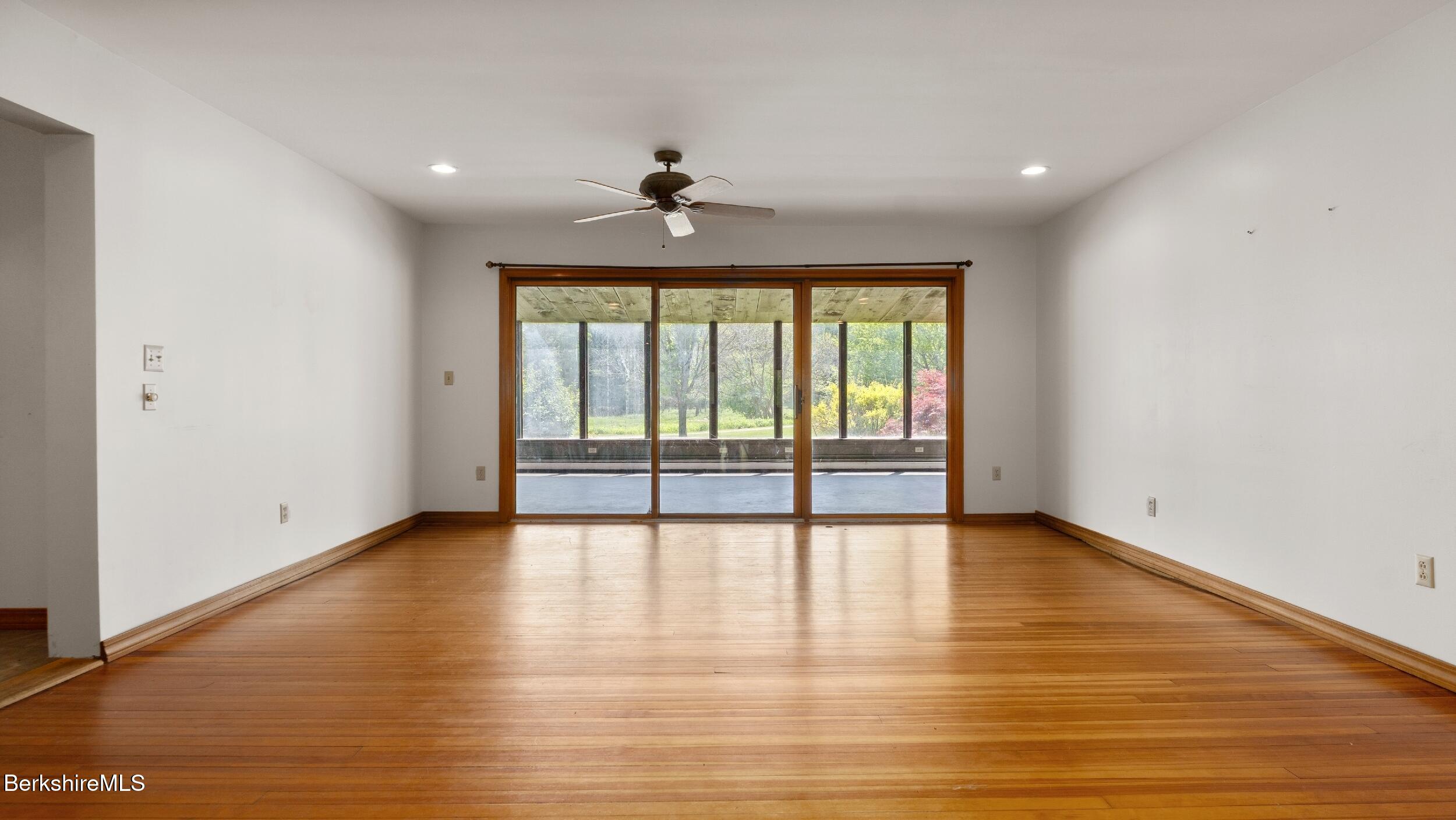 20 East Dugway Road Lenox, MA 01240 - Photo 14 of 84 a view of an empty room with wooden floor and a window