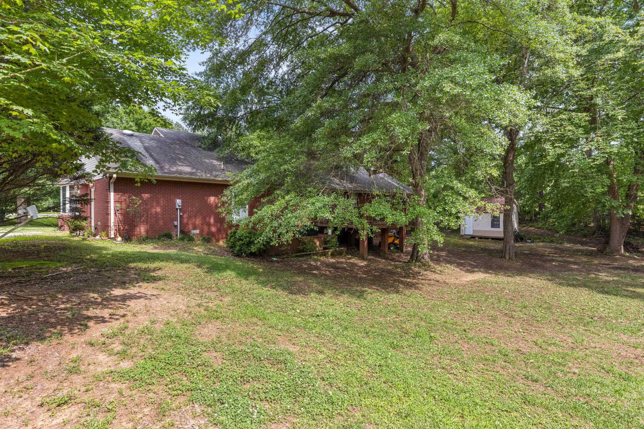 4625 Tucker Road Golden, MS 38847 - Photo 7 of 35 a front view of a house with a garden and tree