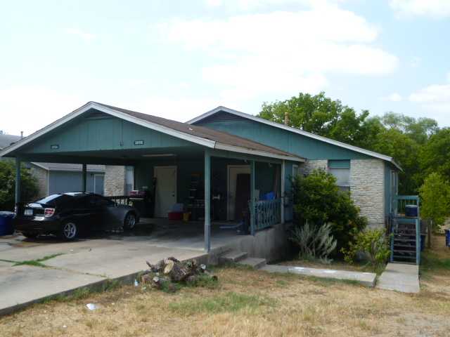 5815 Spring Meadow Road Austin, TX 78744 - Photo 1 of 1 a front view of a house with garden