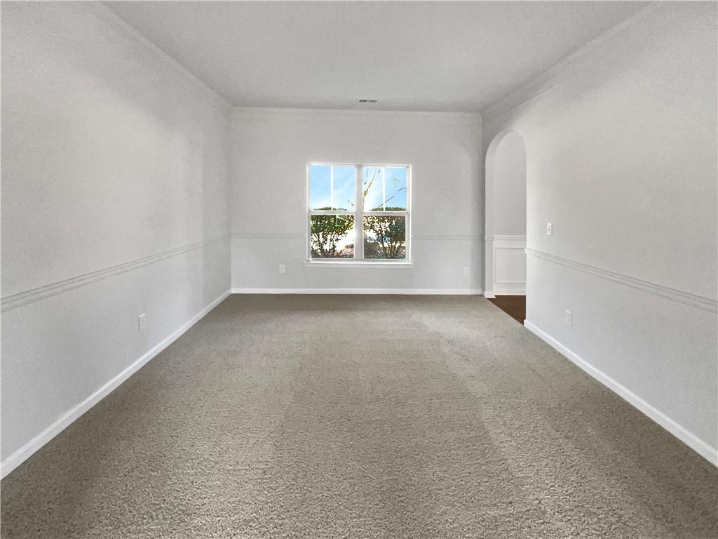 2879 Valaise Lane Lithonia, GA 30038 - Photo 11 of 25 an empty room with windows and a ceiling fan