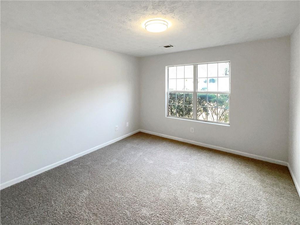 2879 Valaise Lane Lithonia, GA 30038 - Photo 12 of 25 an empty room with windows