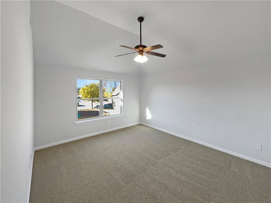 2879 Valaise Lane Lithonia, GA 30038 - Photo 13 of 25 an empty room with windows and fan
