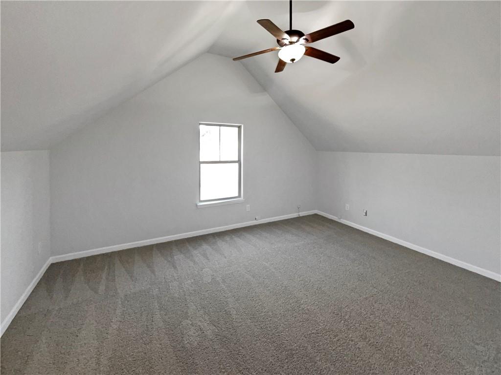 2879 Valaise Lane Lithonia, GA 30038 - Photo 14 of 25 an empty room with windows and fan