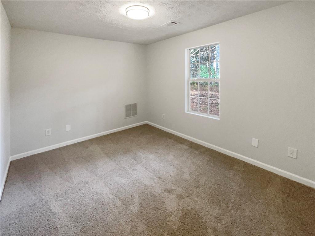 2879 Valaise Lane Lithonia, GA 30038 - Photo 16 of 25 an empty room with a window