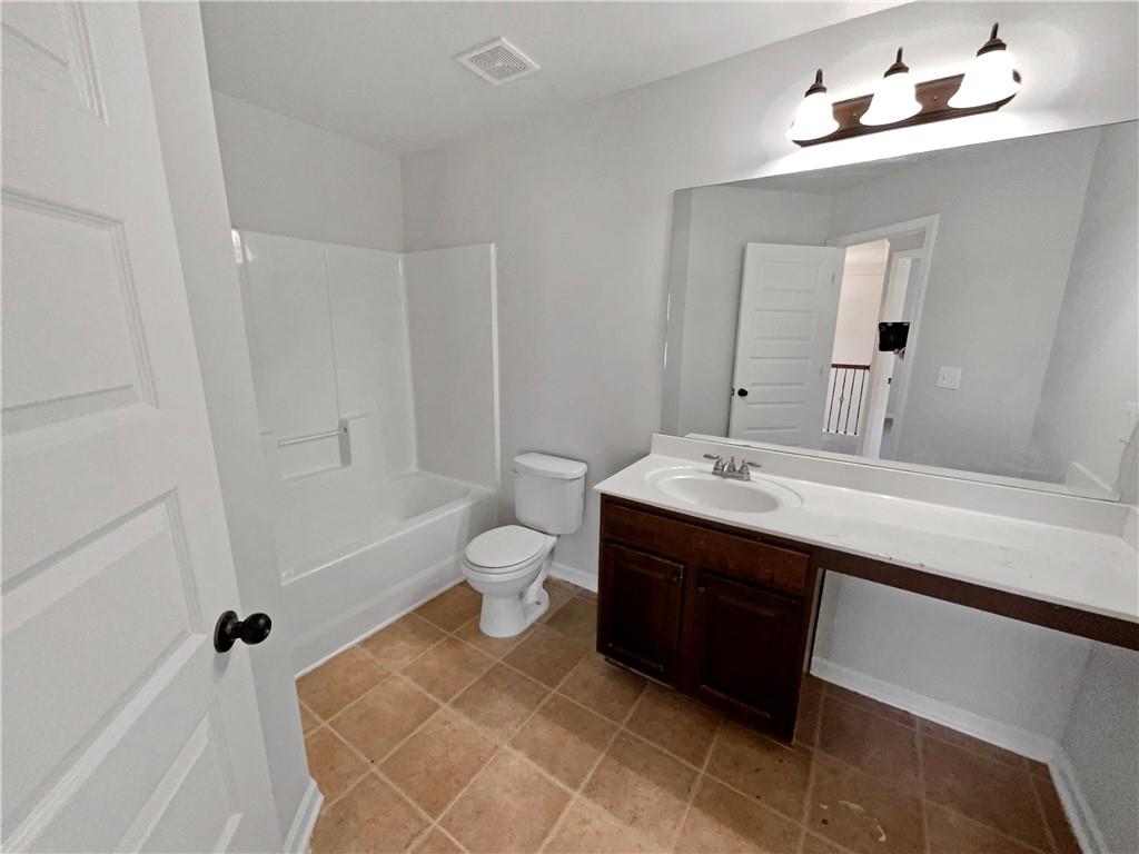 2879 Valaise Lane Lithonia, GA 30038 - Photo 18 of 25 a bathroom with a sink vanity mirror and toilet