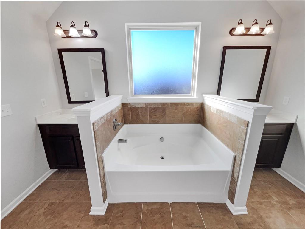 2879 Valaise Lane Lithonia, GA 30038 - Photo 20 of 25 a bathroom with a tub sink and mirror