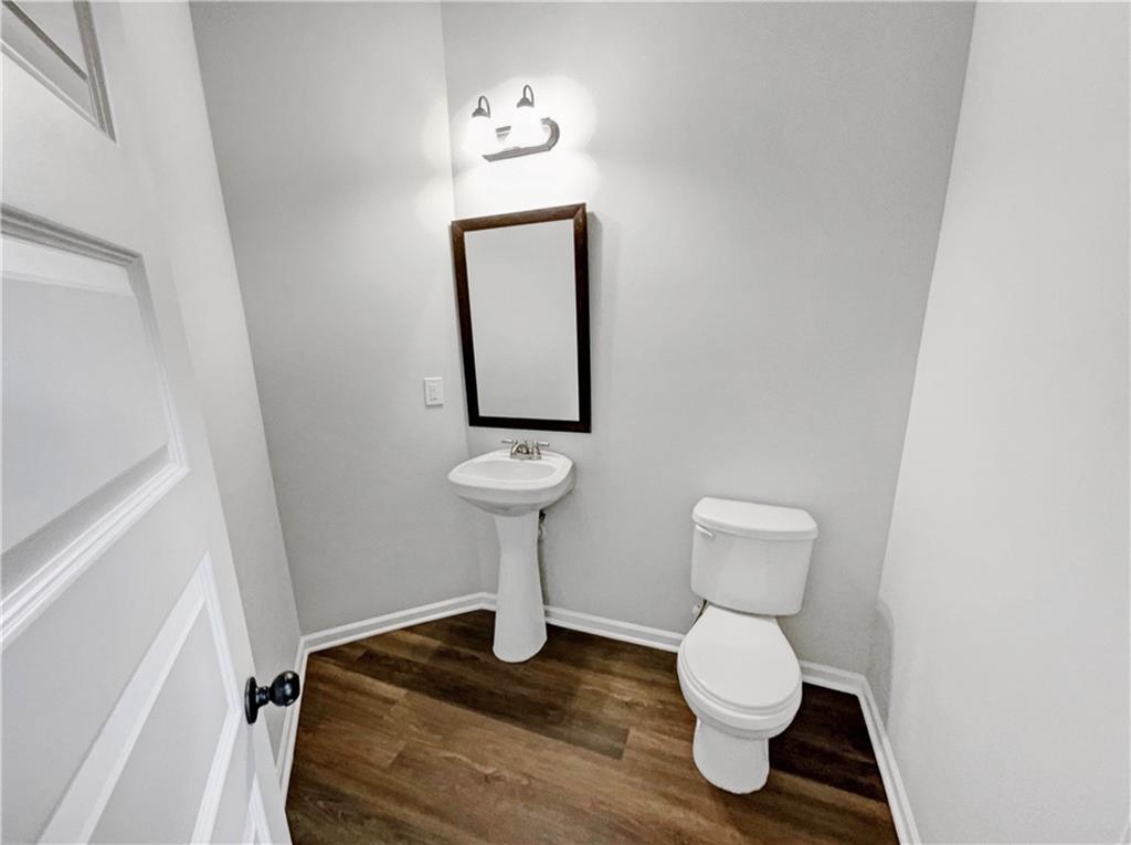 2879 Valaise Lane Lithonia, GA 30038 - Photo 21 of 25 a bathroom with a toilet a sink and mirror