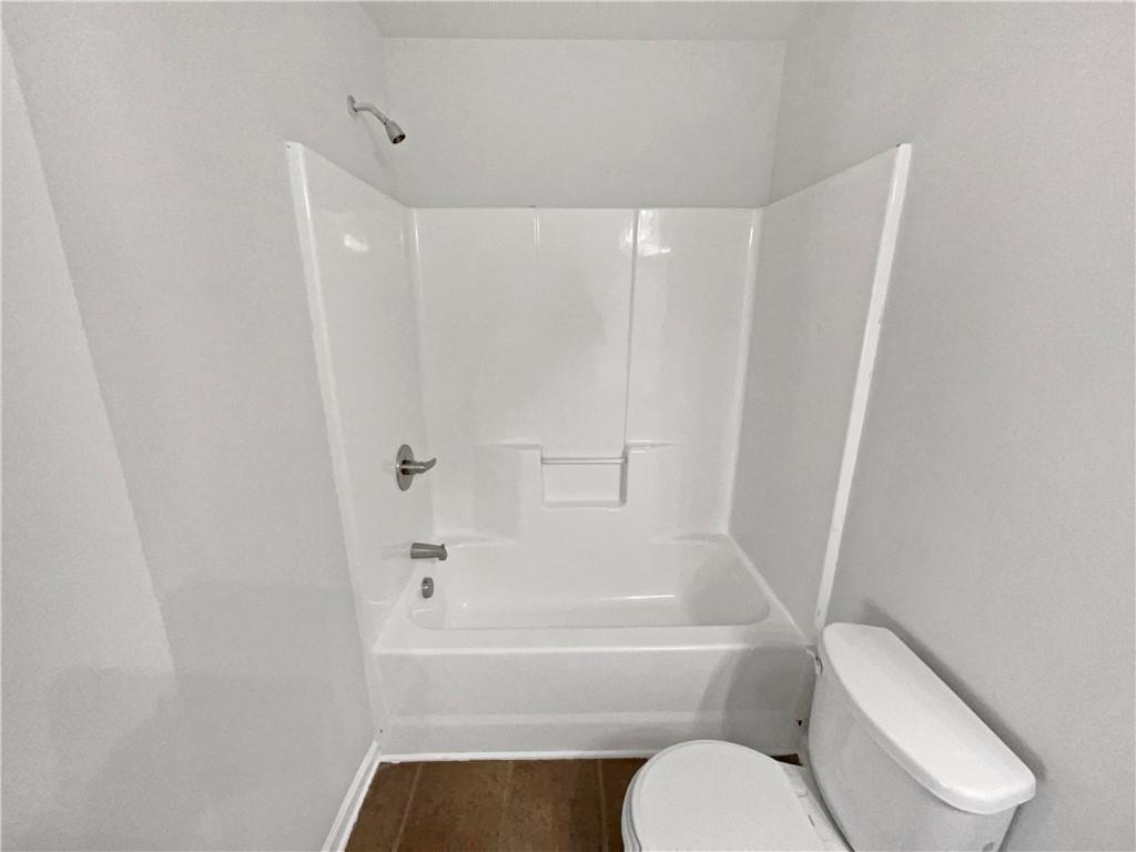 2879 Valaise Lane Lithonia, GA 30038 - Photo 23 of 25 a bathroom with a toilet and a bathtub