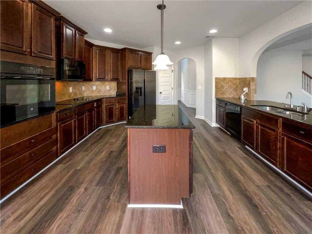 2879 Valaise Lane Lithonia, GA 30038 - Photo 7 of 25 a large kitchen with stainless steel appliances granite countertop a stove a refrigerator a sink and a oven