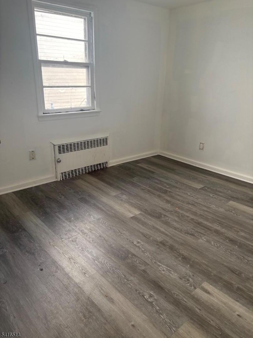 30 Cedar Street Hillside, NJ 07205 - Photo 8 of 10 an empty room with wooden floor and windows