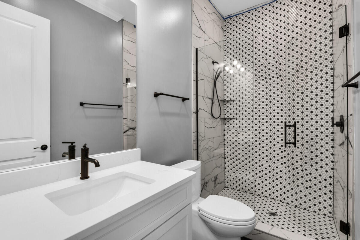 263 Calusa Boulevard Destin, FL 32541 - Photo 5 of 12 a bathroom with a sink toilet and shower