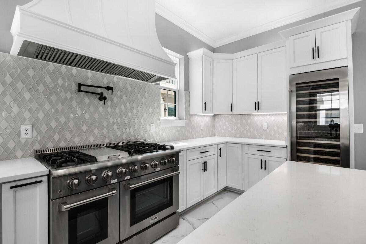 263 Calusa Boulevard Destin, FL 32541 - Photo 8 of 12 a kitchen with granite countertop a stove and a sink